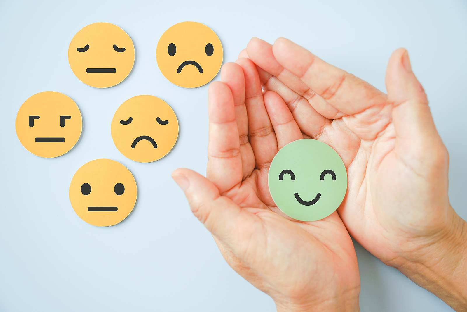 bigstock-Hand-Holding-Happy-Smile-Face--429872690-2